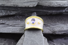 Load image into Gallery viewer, Lady&#39;s Two Tone 18 Karat Satin &amp; Polished Contemporary Fashion Ring With 1 Oval Tanzanite And 2 Round Diamonds View #1
