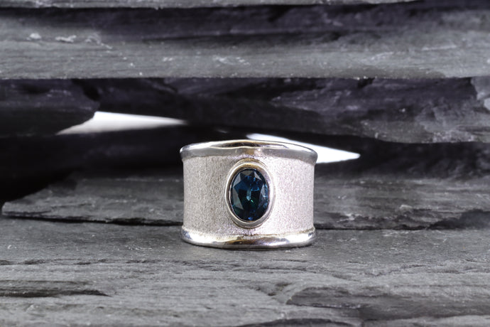 White Sterling Silver Satin & Polished Contemporary Ring Bezel Set With One Oval Blue Topaz