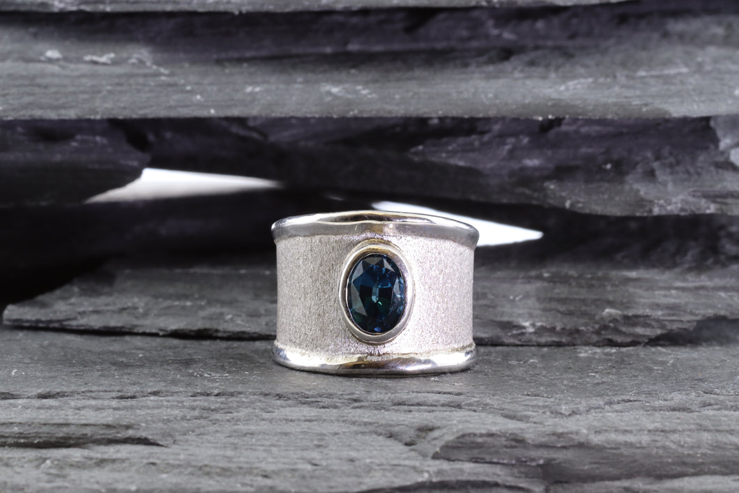 White Sterling Silver Satin & Polished Contemporary Ring Bezel Set With One Oval Blue Topaz
