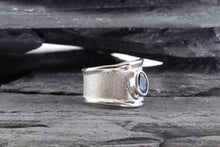 Load image into Gallery viewer, White Sterling Silver Satin &amp; Polished Contemporary Ring With One Oval Blue Topaz., View #2
