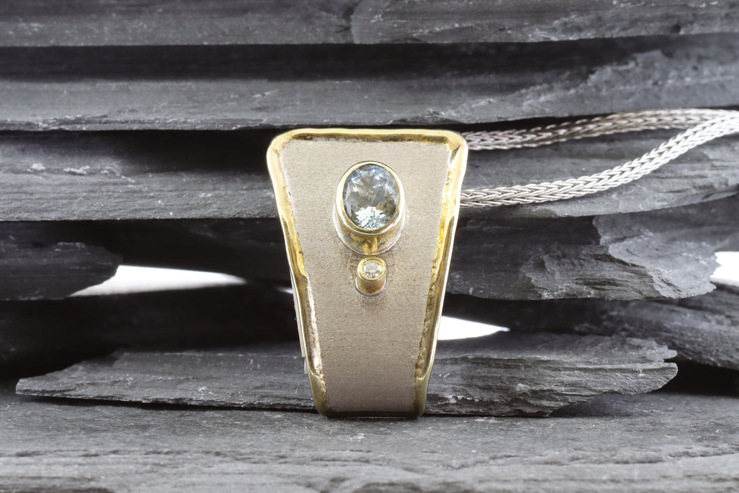 Two Tone Sterling Silver Satin & Polished Bezel Set Pendant With 1YIA  Round Diamond And 1 Oval Aquamarine.